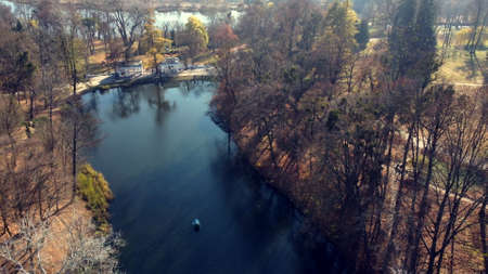 Arial drone view flight over lake in park on sunny autumn dayの写真素材