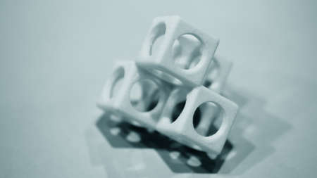 Abstract object of a blue color printed on a 3d printer on a white tableの写真素材