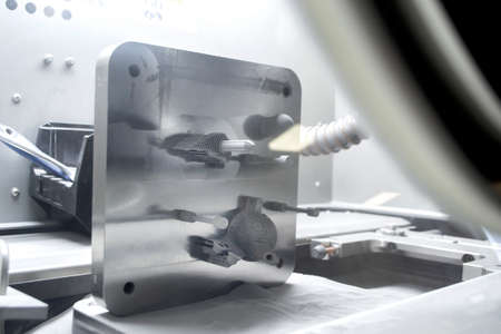 Platform with Objects Printed From Metal Powder Stands in Working Chamber Insideの写真素材