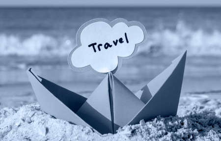 Orange Paper Boat on Sandy Seashore Close-up. Small Boat from Paperの写真素材