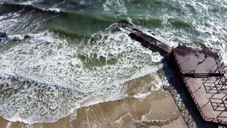Aerial Drone View Flight Over Old Breakwater on Sandy Beach. Top View Wavesの写真素材