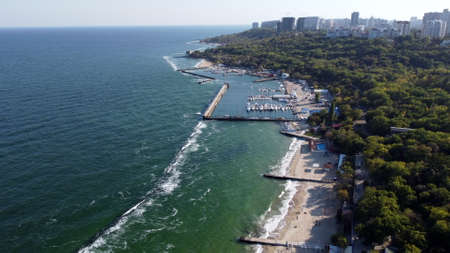 People walking and relaxing on beach on sunny day. Aerial Drone View Flight Overの写真素材