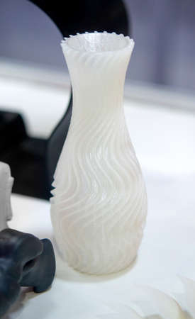 Objects printed on a 3d printer made of white plastic close-up.の写真素材