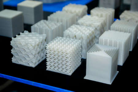 Objects printed on a 3d printer made of white plastic close-up.の写真素材