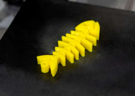 Yellow objects printed on 3D printer from plastic. New 3D printing technology.の写真素材