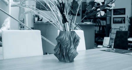 The object vase printed on the 3d printer stands on the tableの写真素材