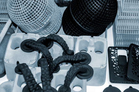 Many different models printed on 3D printer. Gray and black objects printedの写真素材