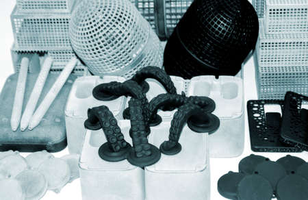 Many different models printed on 3D printer. Gray and black objects printedの写真素材