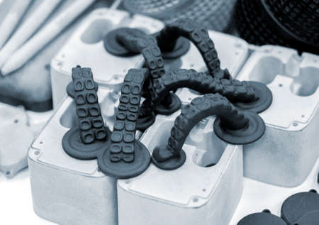 Models printed on 3D printer. Black objects octopus tentacles printed on 3D printer made of plastic close-up. Surface 3D printed models. Prototypes of shapes made by 3d printer. printing technologyの写真素材