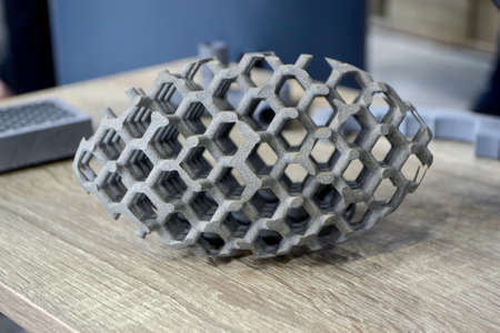 Models printed on 3D printer. Gray objects printed on 3D printer made of plastic close-up. Surface 3D printed models. Prototypes of shapes made by 3d printer. Concept new modern printing technology.の写真素材