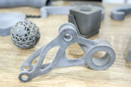 Many different models printed on 3D printer. Gray objects printed on 3D printerの写真素材