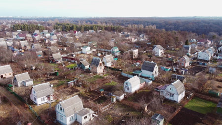 Aerial Drone View Flight Over small brick houses with a plot of land in the middle of the forest on an autumn day. Top viewの写真素材