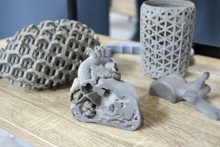Prototype of human heart and art objects printed on 3D printer. Model printed on 3D printer of plastic close-up. 3D printed object. Prototype of shape by 3d printer. New printing technologyの写真素材