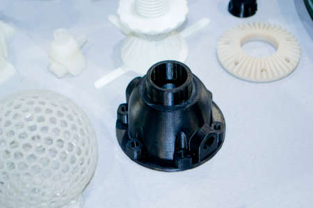 Models printed on 3D printer. Many objects printed on 3D printer made of plastic close-up. Prototypes of various shapes made by 3d printer. 3D printed models. Concept new modern printing technologyの写真素材