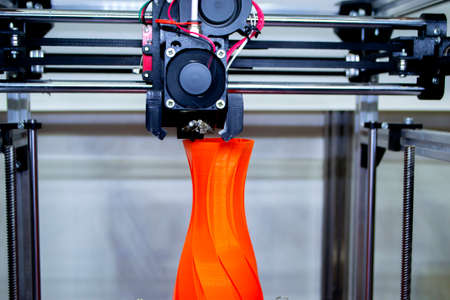 Process printing model on 3d printer. High tech digital printer computer machine in action. Printing mechanism adding layers to object. FDM 3d printer working at 3d printing lab. 3D modern technology.の写真素材