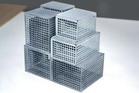 Models printed on 3D printer. Gray plastic objects printed on 3D printer close-up. 3D printed models. Prototypes made by 3d printer. Concept new modern printing technologyの写真素材
