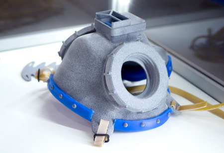 Model respirator printed on 3D printer. Gray objects printed on 3D printer from plastic close-up. 3D printed model. Prototypes of shapes made by 3d printer. Concept new modern printing technology.の写真素材