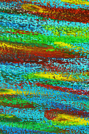 Creative background of colorful brush strokes on canvas closeup. Abstract art background from smeared brush strokes of green red blue yellow colors macro. Drawing painting paint texture backdropの写真素材