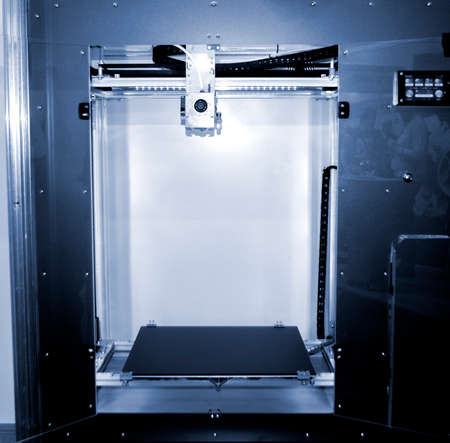 Empty 3d printer close-up. 3d printer with empty desktop inside. Non-printing open 3dprinter. Cope...