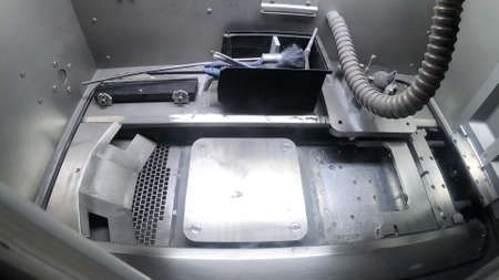 Empty Working Chamber of 3D Printer for Metal Close-up. Laser Sintering Machine for Metal. Additive New Modern Progressive Technology. Metal 3D Printer Inside. Clean Working Chamber Metal 3D Printerの写真素材