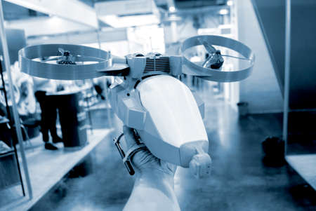 Prototype model helicopter printed on 3d printer close-up. Person holding in his hand a model of a plastic drone that was printed by a 3D printer. Concept new modern 3D printing additive technology.の写真素材