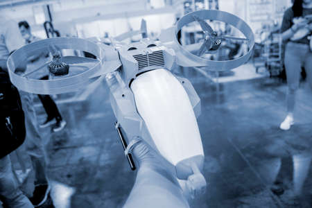 Prototype model helicopter printed on 3d printer close-up. Person holding in his hand a model of a plastic drone that was printed by a 3D printer. Concept new modern 3D printing additive technology.の写真素材