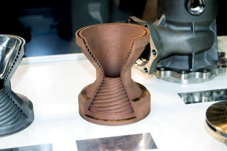 Model object of a large industrial part printed on a 3D printer from metal close-up. New modern progressive additive 3D printing technology. Industry factory plant manufacturing metalwork industrialの写真素材