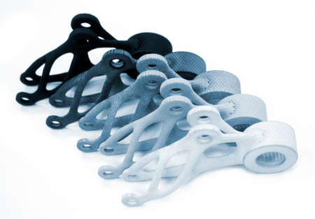 Models printed on 3D printer isolated on white background. Objects details printed on 3D printer from plastic close-up. Prototypes of shapes made by 3d printer. Concept new modern printing technologyの写真素材