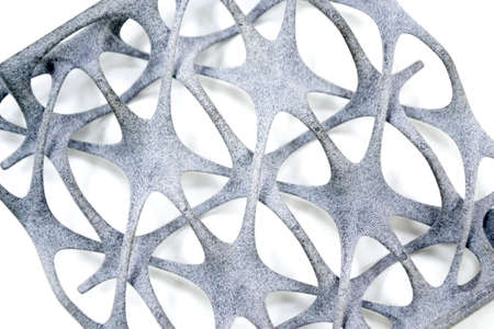 Model printed on 3D printer isolated on white background. Object details printed on 3D printer from plastic close-up. Prototype of shape made by 3d printer. Concept new modern printing technologyの写真素材