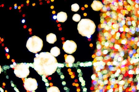Large New Years Christmas tree decorated with luminous multi-colored garlands and illumination at night. Christmas tree with flashing lights. Blurred background. New Year and Christmas holidaysの写真素材