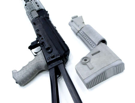 Detail of a weapon printed on a 3D printer. A weapon detail printed on a 3D printer from powder isolated on white background.の写真素材