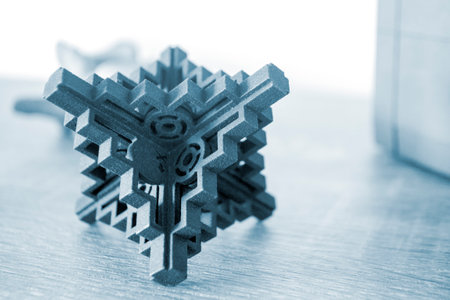 Prototype model printed with powder 3D printer close-up. Abstract black figure printed on a 3D...