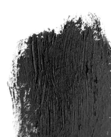 Brush strokes of black acrylic paint close-up. Edge of Smeared Acrylic Black Spot isolated on white background. Abstract creative background. Art drawing texture concept. Copy space, space for textの写真素材