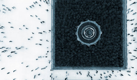 Aerial Drone View Flight Over many people skating on open-air ice rink in winter. Urban Ice skating...