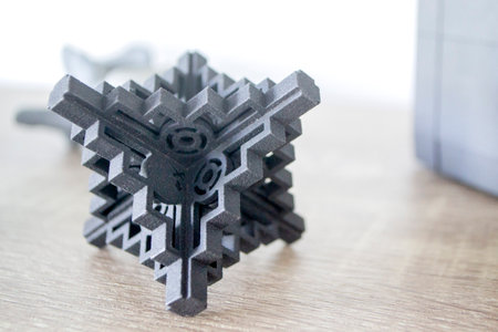Prototype model printed with powder 3D printer close-up. Abstract black figure printed on a 3D printer from polyamide powder. Multi Jet Fusion MJF. New additive modern progressive 3D priner technologyの写真素材