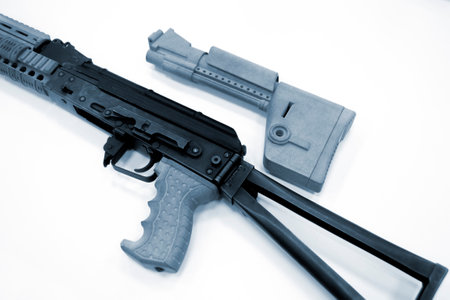 3D printed weapon parts. Assembly of weapons rifle, some parts printed on 3D printer. Details of gray color of weapon printed on 3D printer from polyamide powder. Progressive additive technologyの写真素材