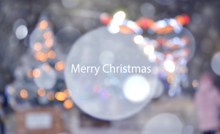 Beautiful Christmas trees decorated with luminous garlands on the street during heavy snowfall. Blurred white snowflake spot in the center. Blurred background. New Year Christmas holidays celebrationの写真素材