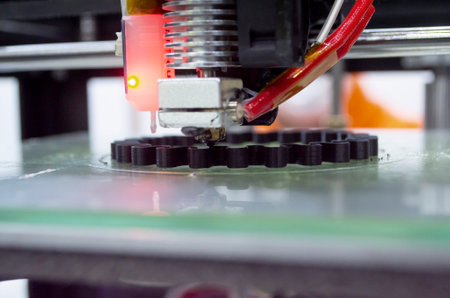 3d printer printing a model close-up. The process of printing a model on a 3D printer made of orange...