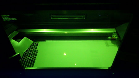 Working 3d printer for metal. 3D printer printing object from metal powder in working chamber by sintering metal powder under laser. SLM. Selective laser melting technology. Melting metal powderの写真素材