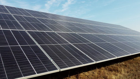 Solar power plant. Flight over modules of solar power station on sunny day. Renewable electrical energy. Alternative green electricity power. photovoltaic modules photobatteries. New modern technologyの写真素材