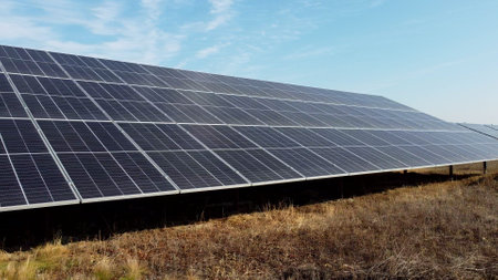 Solar power plant. Flight over modules of solar power station on sunny day. Alternative green electricity power. New modern technology. Renewable electrical energy. photovoltaic modules photobatteriesの写真素材