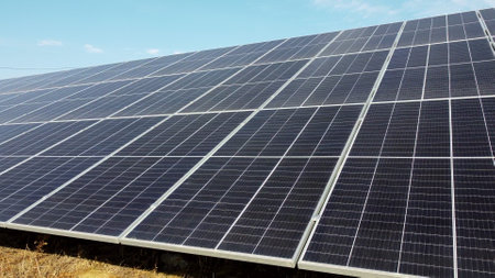 Solar power plant. Flight over modules of solar power station on sunny day. Alternative green electricity power. New modern technology. Renewable electrical energy. photovoltaic modules photobatteriesの写真素材