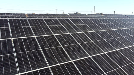 Solar power plant. Flight over modules of solar power station on sunny day. Renewable electrical energy. Alternative green electricity power. photovoltaic modules photobatteries. New modern technologyの写真素材