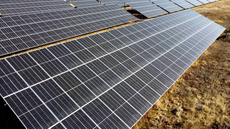 Solar power plant. Flight over modules of solar power station on sunny day. Alternative green electricity power. New modern technology. Renewable electrical energy. photovoltaic modules photobatteriesの写真素材