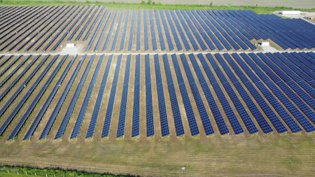 Solar power plant. Many blue panels of a large solar power plant. Aerial drone view. Solar power station. Green clean electricity. New modern technologies. Ecological alternative innovation technologyの写真素材