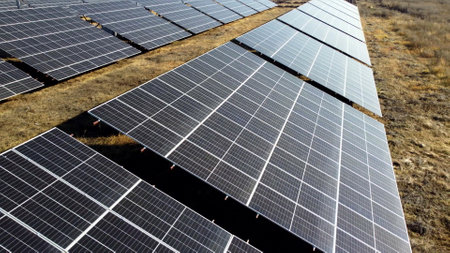 Solar power plant. Flight over modules of solar power station on sunny day. Alternative green electricity power. New modern technology. Renewable electrical energy. photovoltaic modules photobatteriesの写真素材