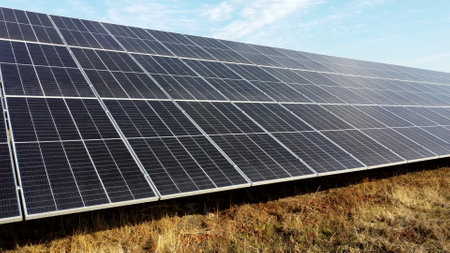 Solar power plant. Flight over modules of solar power station on sunny day. Alternative green electricity power. New modern technology. Renewable electrical energy. photovoltaic modules photobatteriesの写真素材