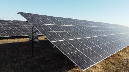 Solar power plant. Flight over modules of solar power station on sunny day. Alternative green electricity power. New modern technology. Renewable electrical energy. photovoltaic modules photobatteriesの写真素材