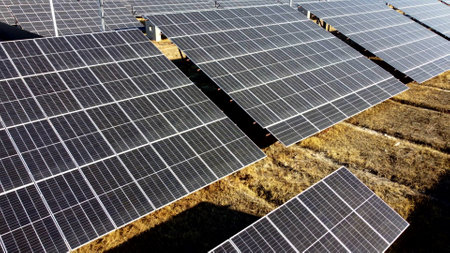 Solar power plant. Flight over modules of solar power station on sunny day. Renewable electrical energy. Photovoltaic modules photobatteries. New modern technology. Alternative green electricity powerの写真素材
