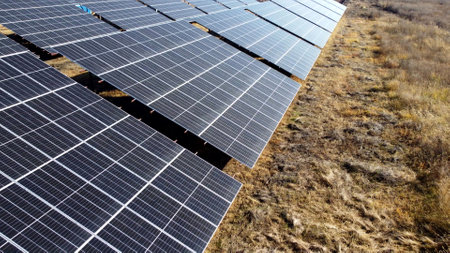 Solar power plant. Flight over modules of solar power station on sunny day. Alternative green electricity power. New modern technology. Renewable electrical energy. photovoltaic modules photobatteriesの写真素材